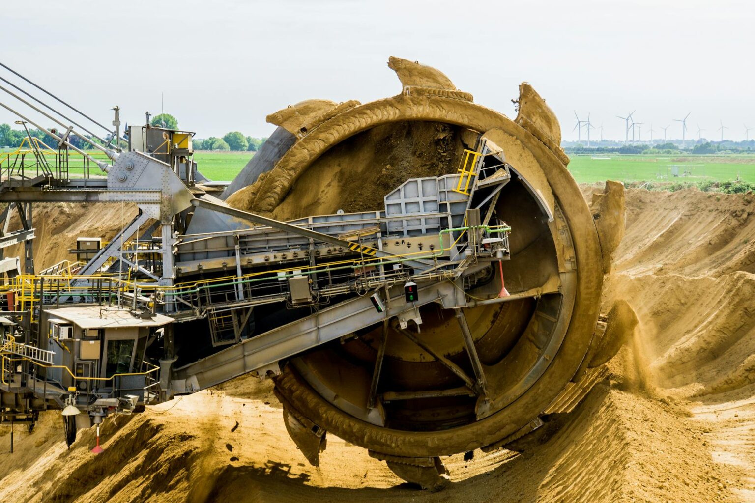 How Electric Vehicle Battery Demand Is Creating Nickel Mining Opportunities Large mining excavator operating at an open pit mine site