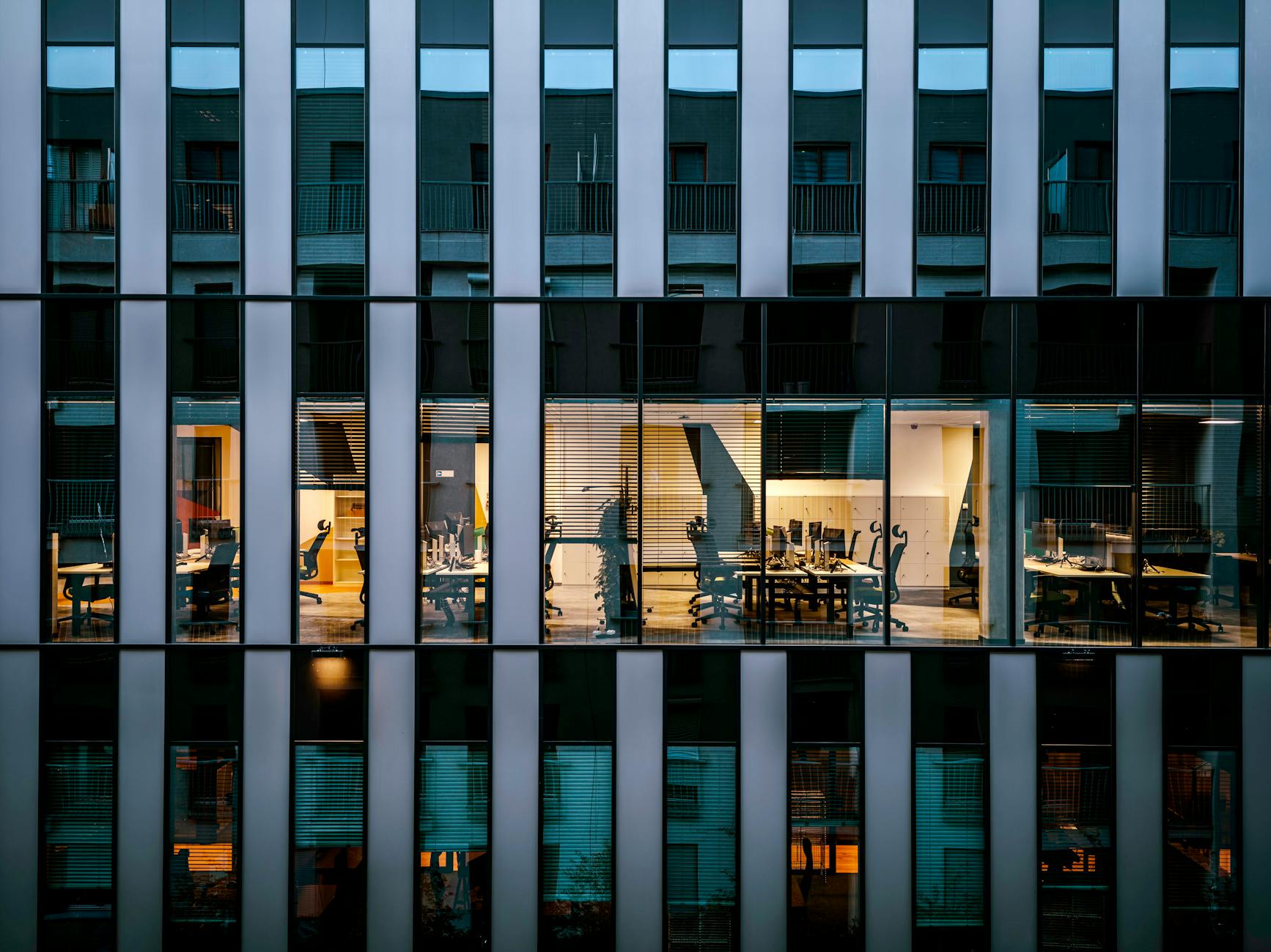 Modern glass office building exterior showing commercial real estate that could be converted to data center use