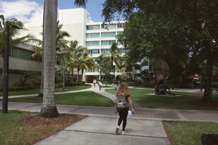 Modern university campus buildings with green spaces and walkways
