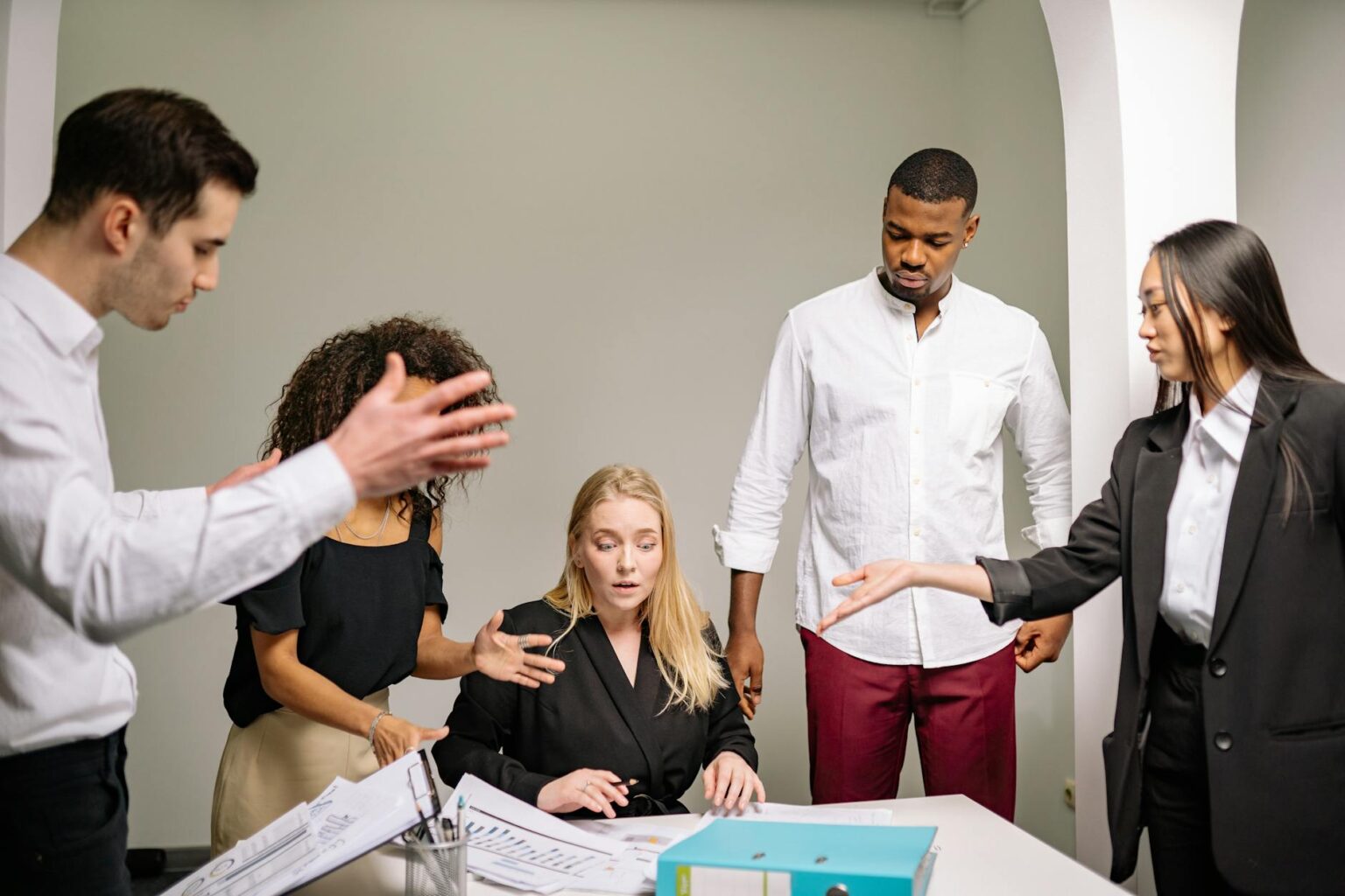 How Corporate Sabbatical Programs Are Reducing Employee Turnover Costs Business professionals in a modern office meeting room discussing employee benefits and retention strategies