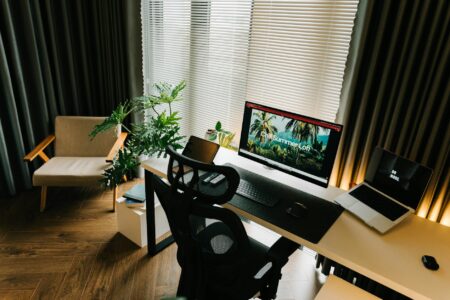 Why Corporate Remote Work Stipends Are Replacing Office Space Investments Modern home office workspace with laptop, monitor, and ergonomic chair showing remote work environment