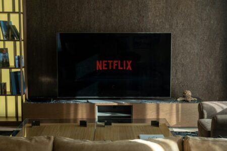 Modern flat screen TV displaying streaming service interface with multiple content options