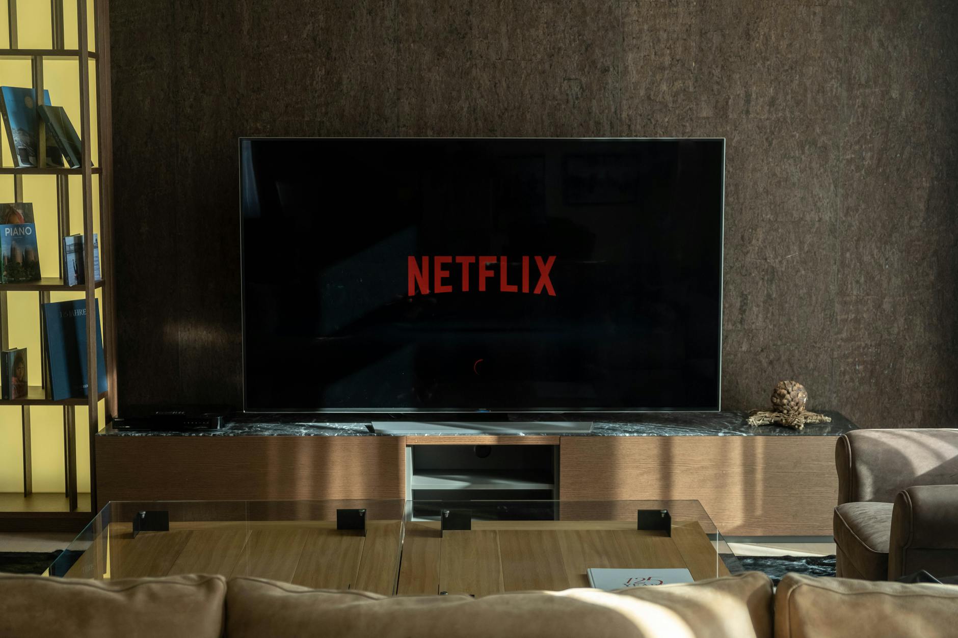 Modern flat screen TV displaying streaming service interface with multiple content options