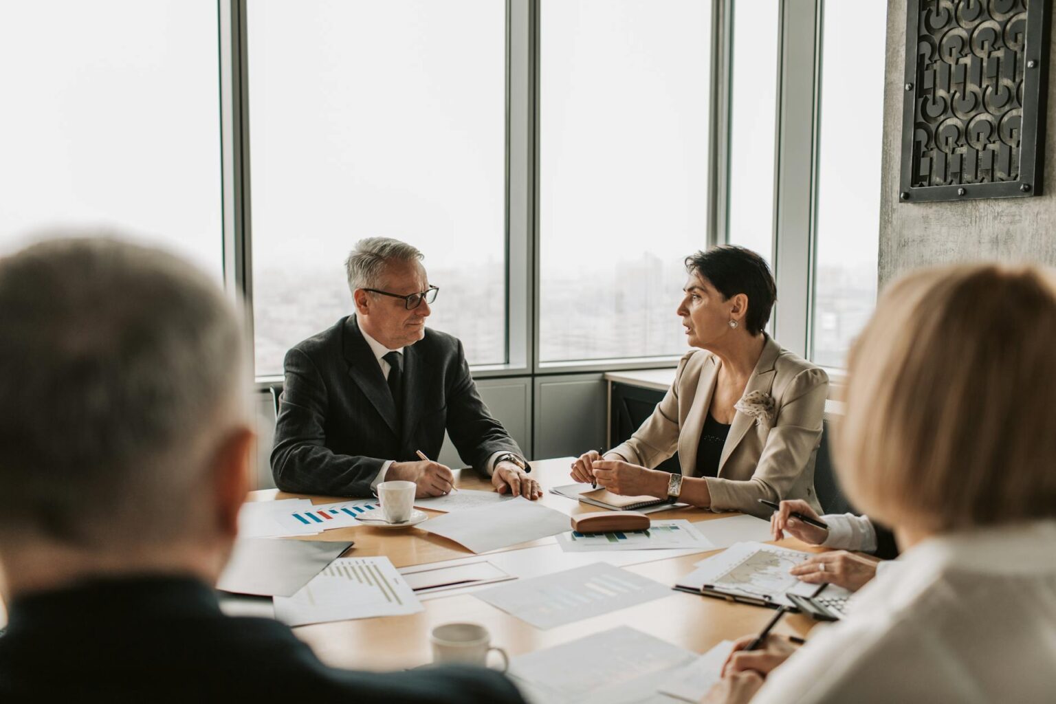 Why Corporate Dividend Cuts Are Accelerating Despite Record Profits Corporate executives discussing financial strategy in modern boardroom setting