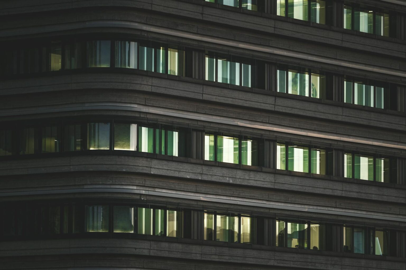 How Corporate Return-to-Office Mandates Are Boosting Downtown Real Estate Values Modern office building exterior in downtown business district with glass facade