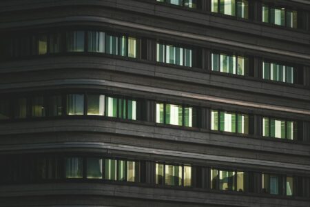 How Corporate Return-to-Office Mandates Are Boosting Downtown Real Estate Values Modern office building exterior in downtown business district with glass facade