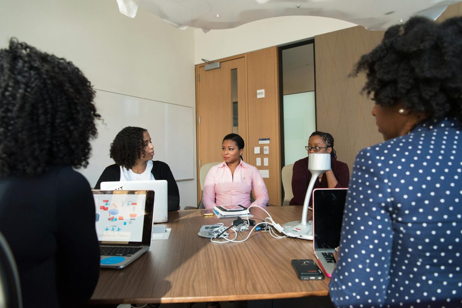 Why Corporate Quiet Quitting Policies Are Reducing Middle Management Roles Empty corporate meeting room with conference table and chairs, representing reduced management oversight