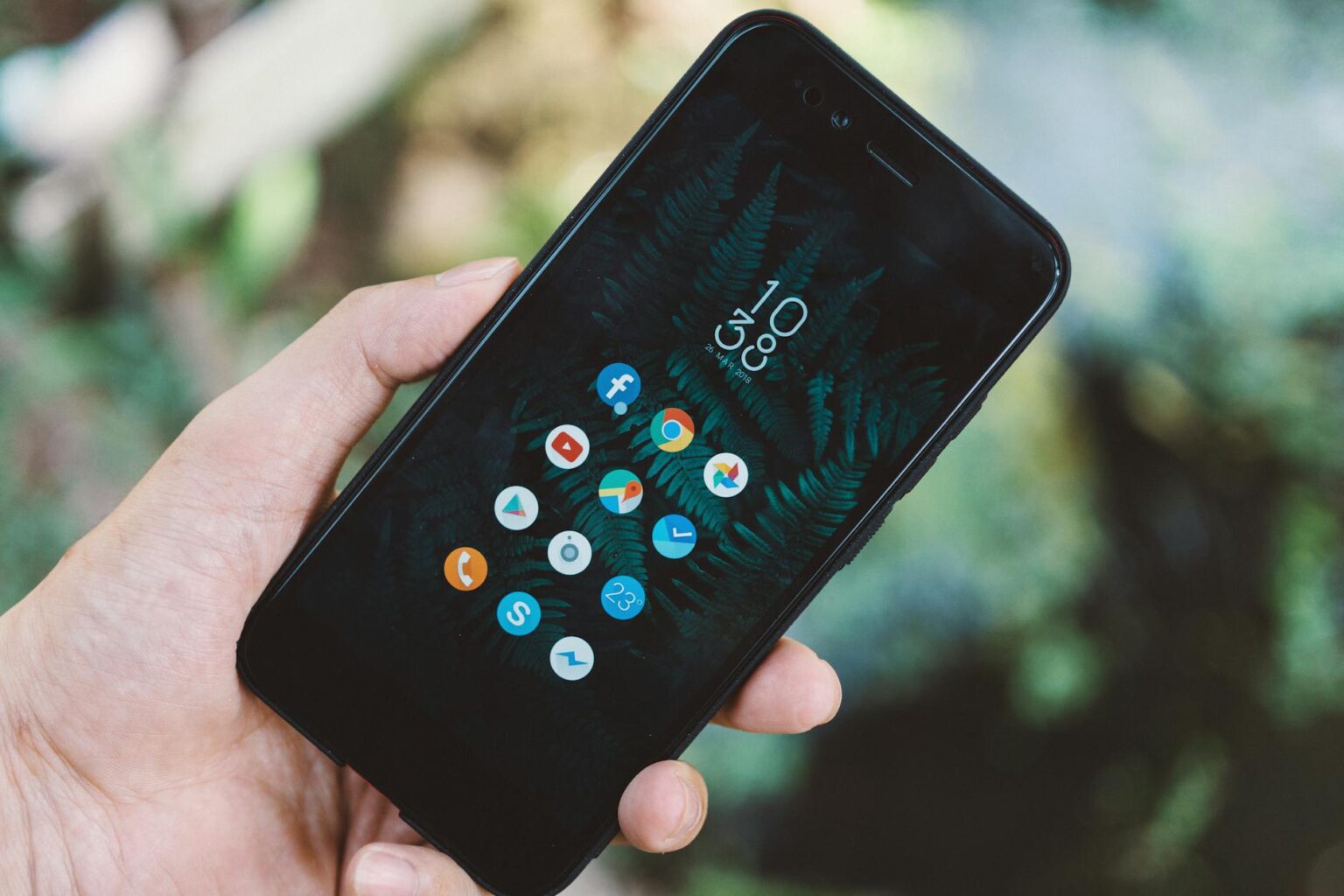 How Major Social Media Platforms Are Monetizing User-Generated Financial Content Person holding smartphone displaying social media financial content and investment apps