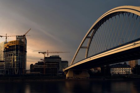 How Government Infrastructure Spending Is Boosting Municipal Bond Yields Construction workers building modern bridge infrastructure representing municipal infrastructure projects