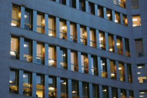 How Corporate Four-Day Workweeks Are Reducing Energy Consumption Costs Modern office building with glass windows during daytime showing corporate workplace setting