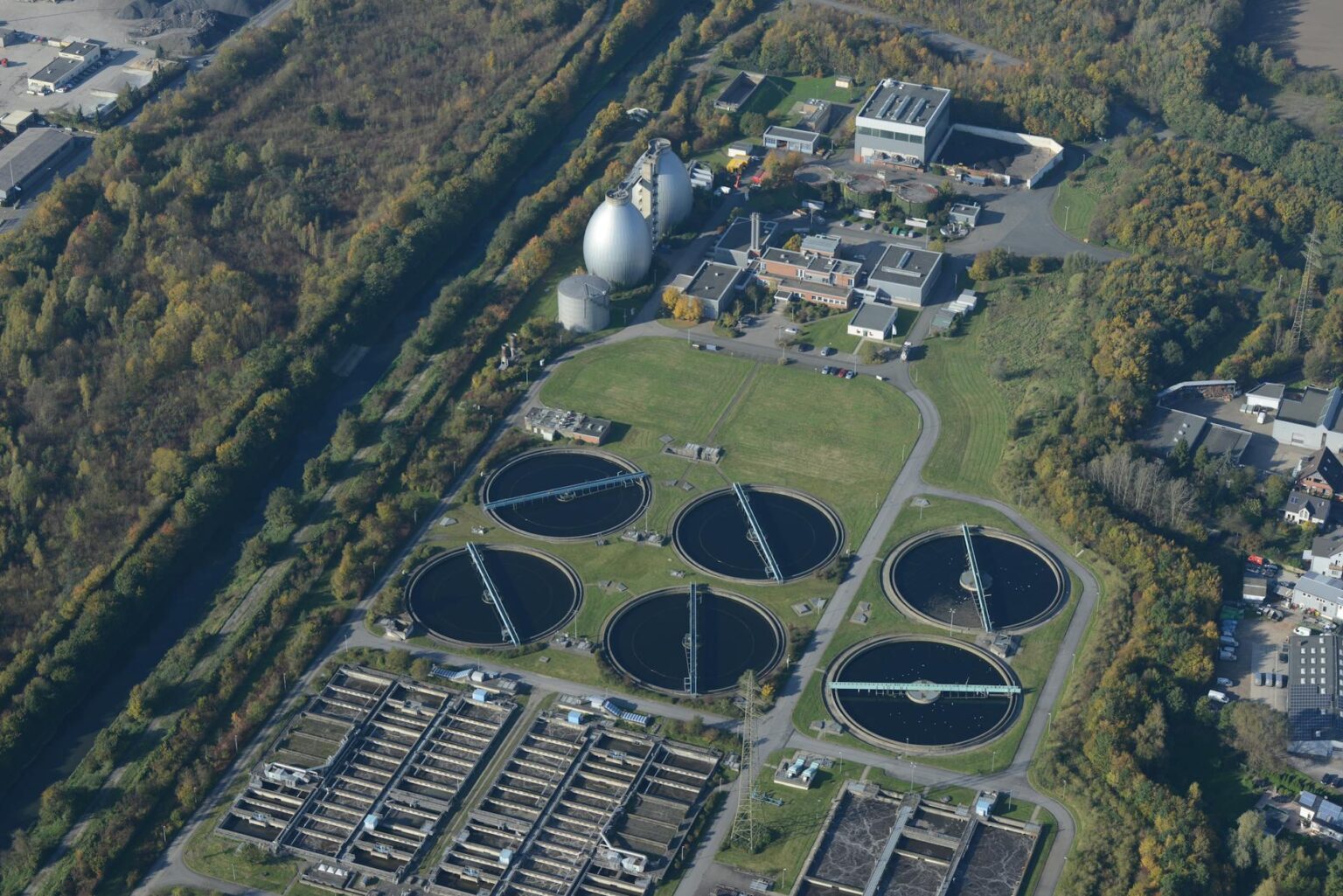 How Rising Water Scarcity Is Driving Desalination Technology Investment Growth Industrial water treatment facility with large cylindrical tanks and processing equipment