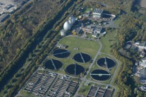 How Rising Water Scarcity Is Driving Desalination Technology Investment Growth Industrial water treatment facility with large cylindrical tanks and processing equipment