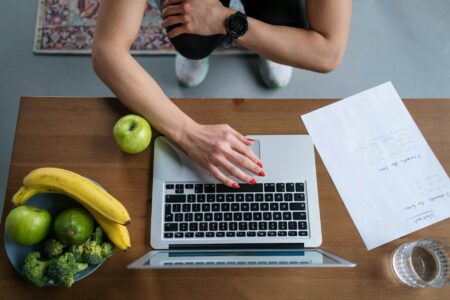 Corporate Wellness Programs Are Becoming Mandatory Across Fortune 1000 Companies Modern office wellness area with exercise equipment and health monitoring stations