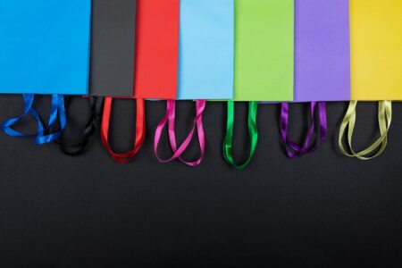 How Student Loan Forgiveness Programs Are Affecting Consumer Spending Patterns Colorful shopping bags representing increased consumer spending from student loan forgiveness recipients