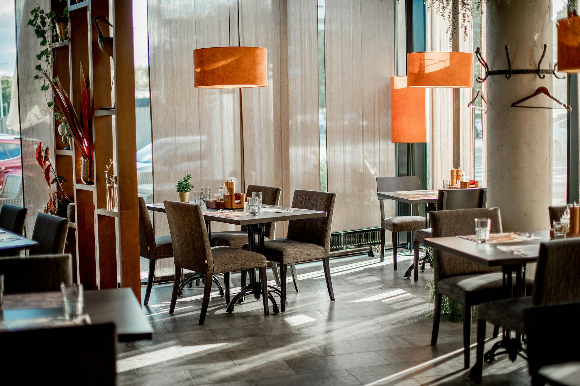 Empty restaurant dining room with vacant tables and chairs