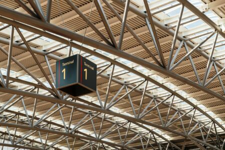 Why Major Airlines Are Partnering With Coworking Spaces for Business Travelers Business travelers working in modern airport terminal with laptops and mobile devices