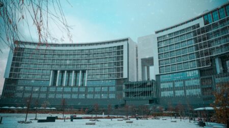 How Corporate Snow Day Policies Are Affecting Productivity Metrics Nationwide Snow-covered corporate office building with empty parking lot during winter storm