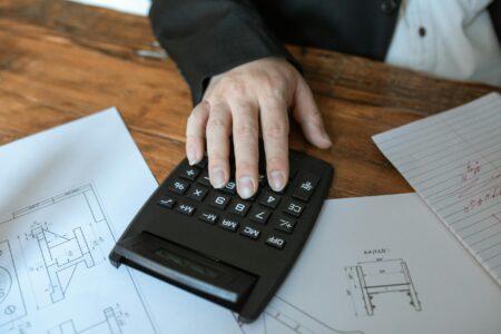 How Social Security Cost-of-Living Adjustments Are Affecting Retirement Planning Senior person reviewing financial documents and calculations at desk