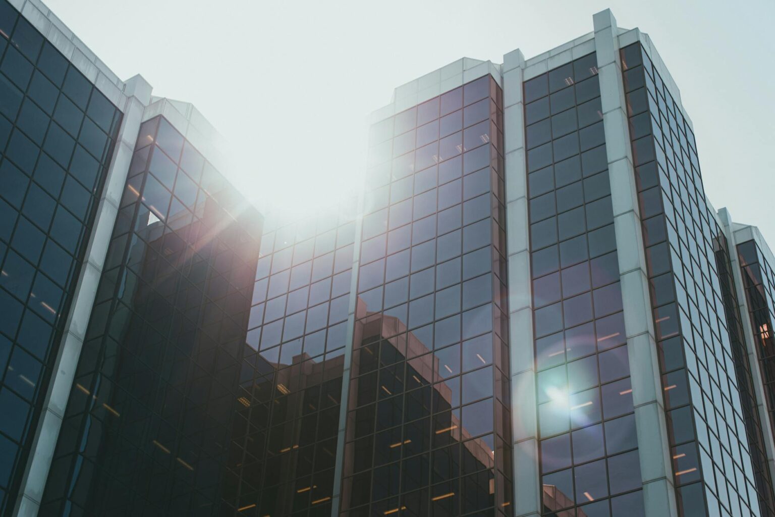 Why Corporate Name Changes Are Signaling Industry-Wide Pivots Modern corporate office building exterior with glass facade representing business transformation