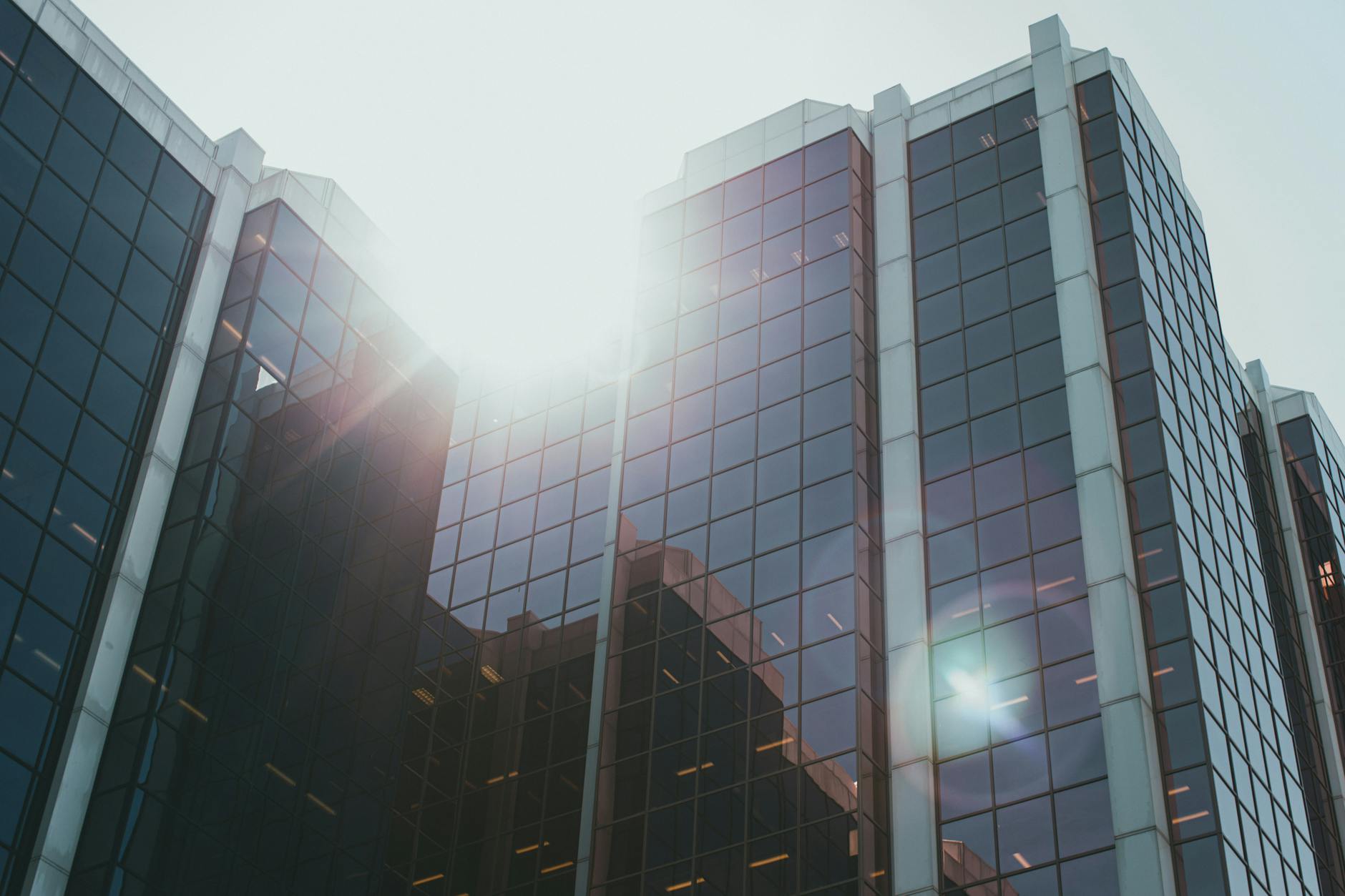 Modern corporate office building exterior with glass facade representing business transformation