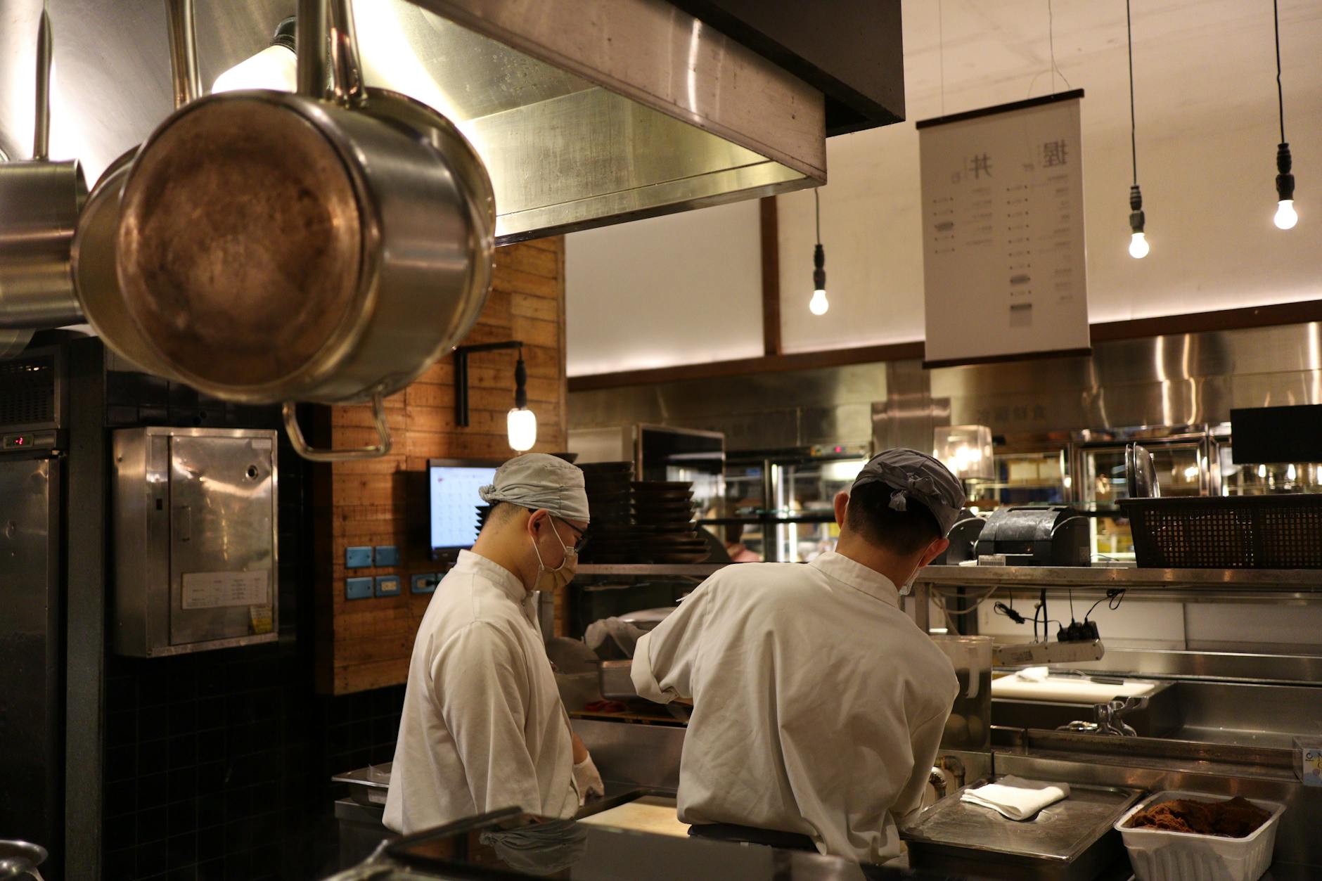 Professional commercial kitchen with stainless steel equipment and prep stations