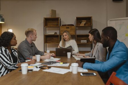 Business professionals discussing productivity metrics in modern office meeting room