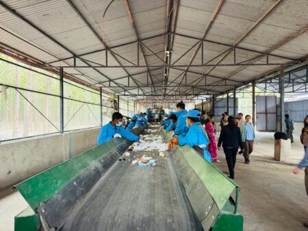 Why Lithium Battery Recycling Stocks Are Attracting ESG Investors Industrial recycling facility with machinery processing materials