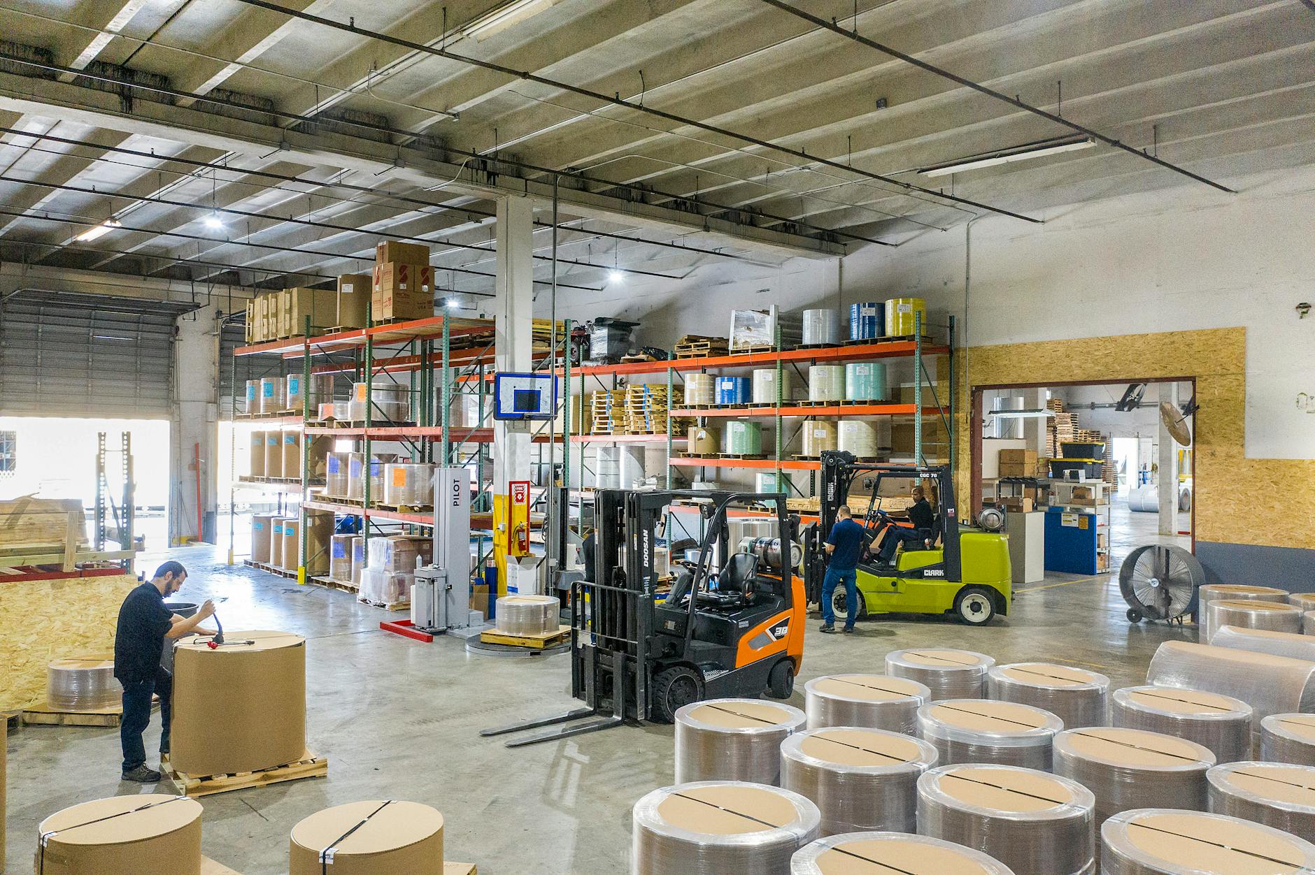 Large technology warehouse with organized storage systems and logistics equipment