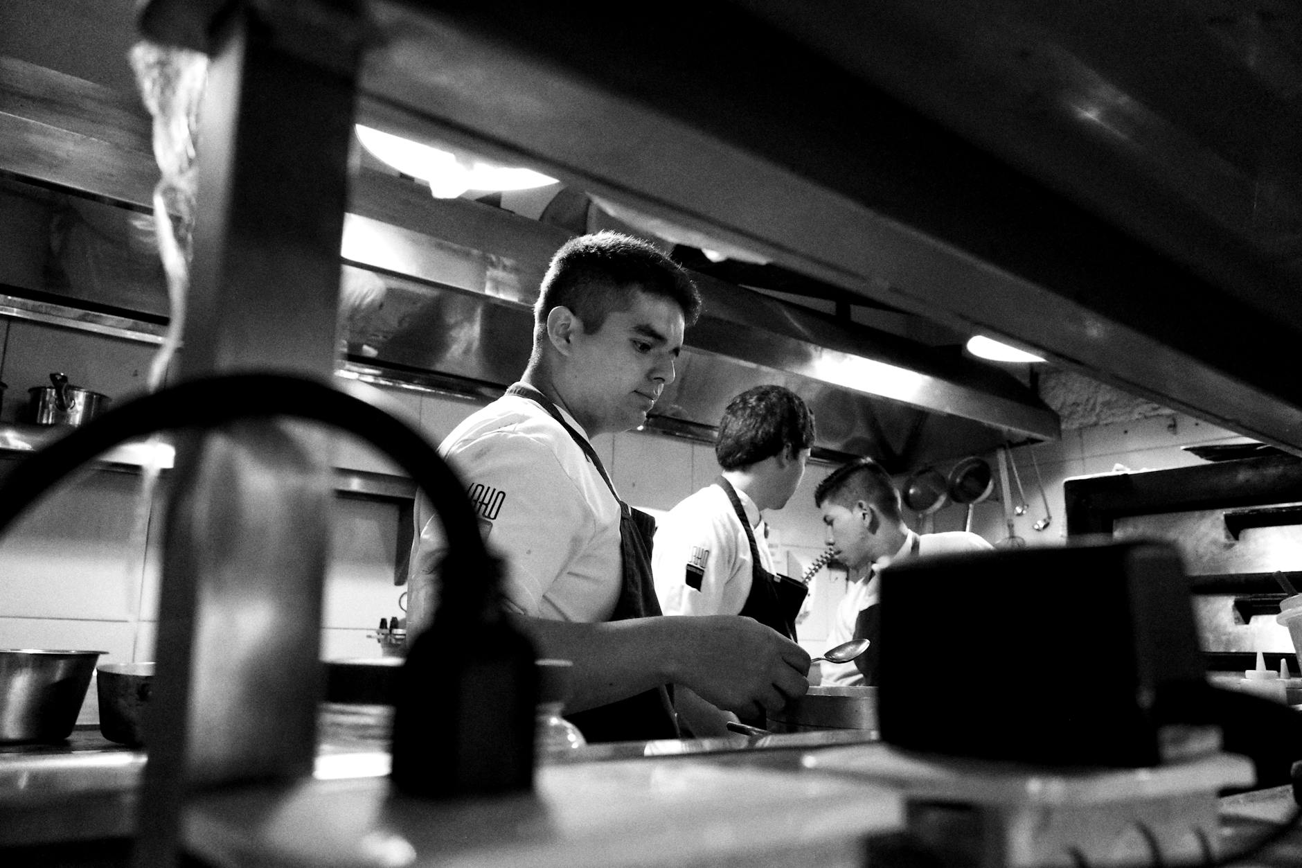 Professional chef working in commercial kitchen preparing food