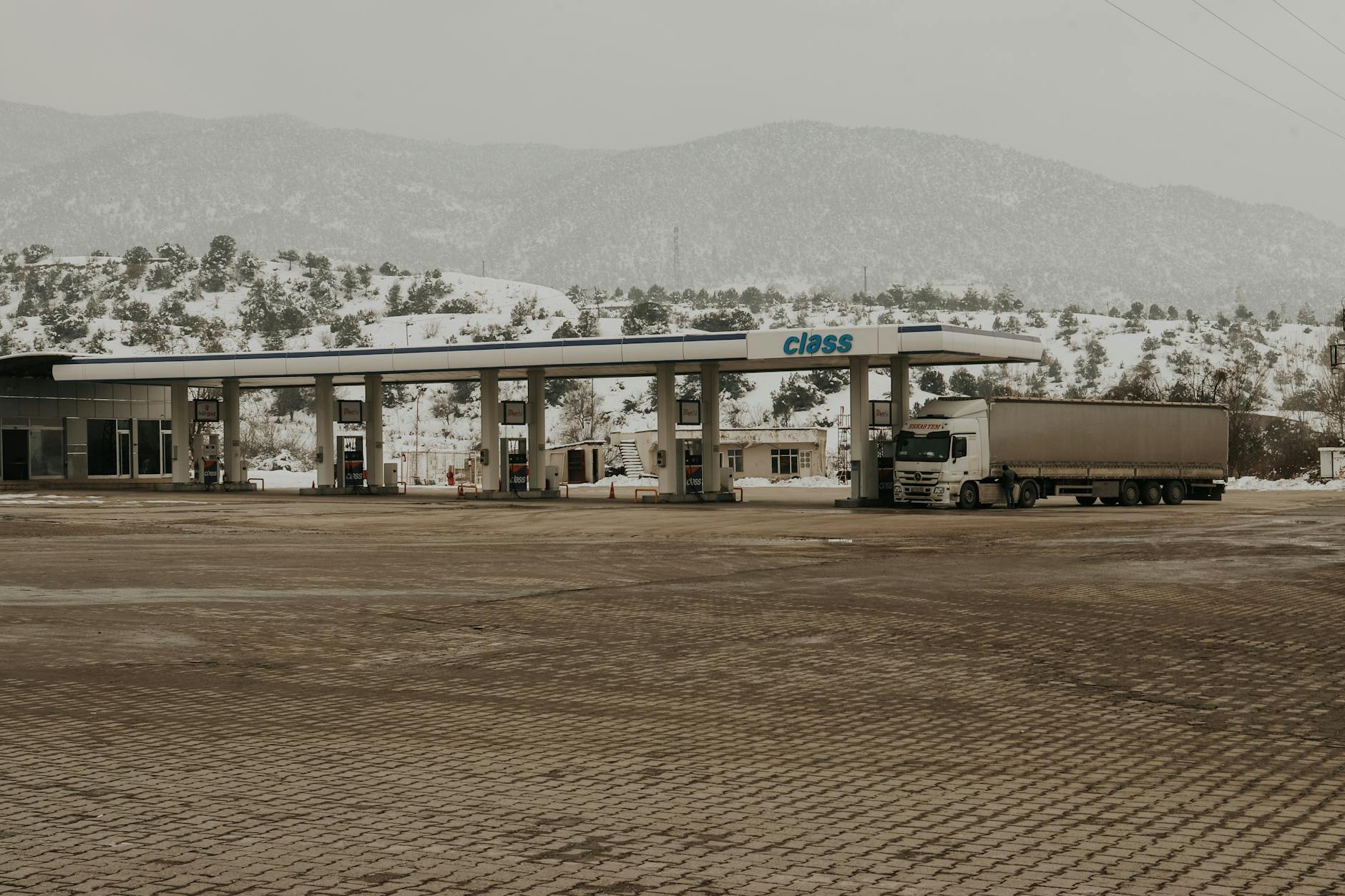 Highway rest area with parking spaces and commercial buildings