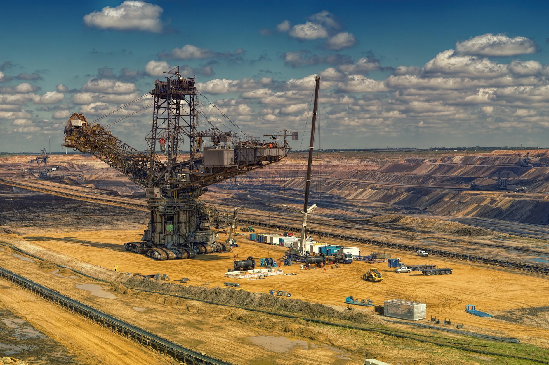Large copper mining operation with heavy machinery extracting ore from open pit mine