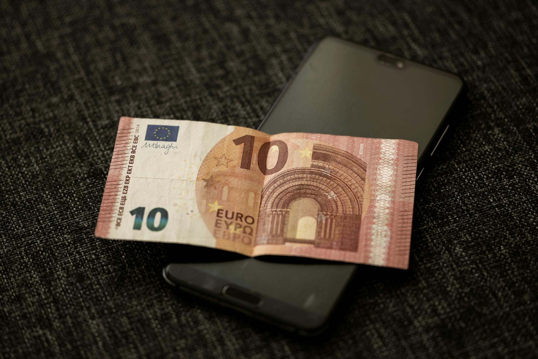 Person using mobile phone for sports betting app demonstrating digital transformation in gaming industry