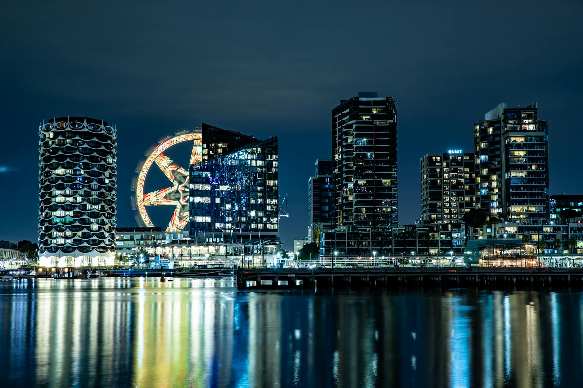 Illuminated waterfront cityscape at night with harbor views