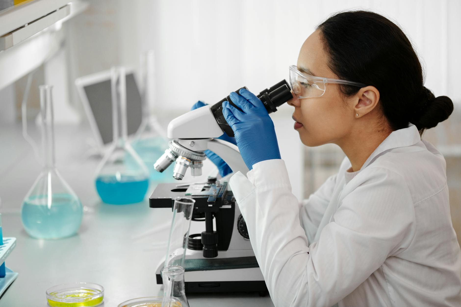 Food scientist in white lab coat working with testing equipment to develop new food ingredients