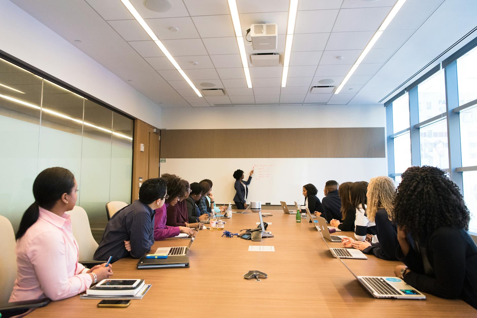 Modern conference room with natural light and plants demonstrating wellness-integrated commercial space design