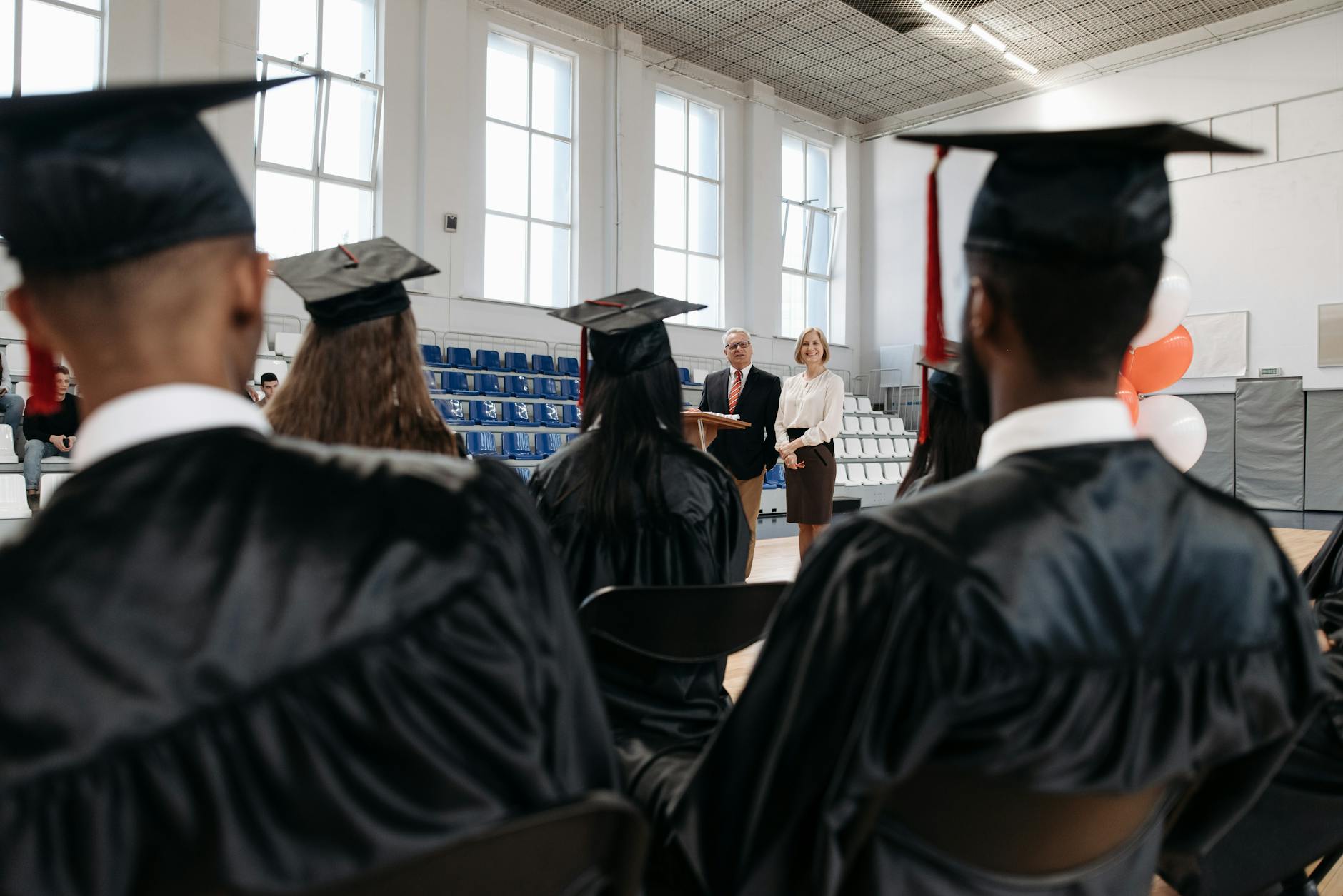 Corporate graduation ceremony with apprentices receiving certificates in professional setting