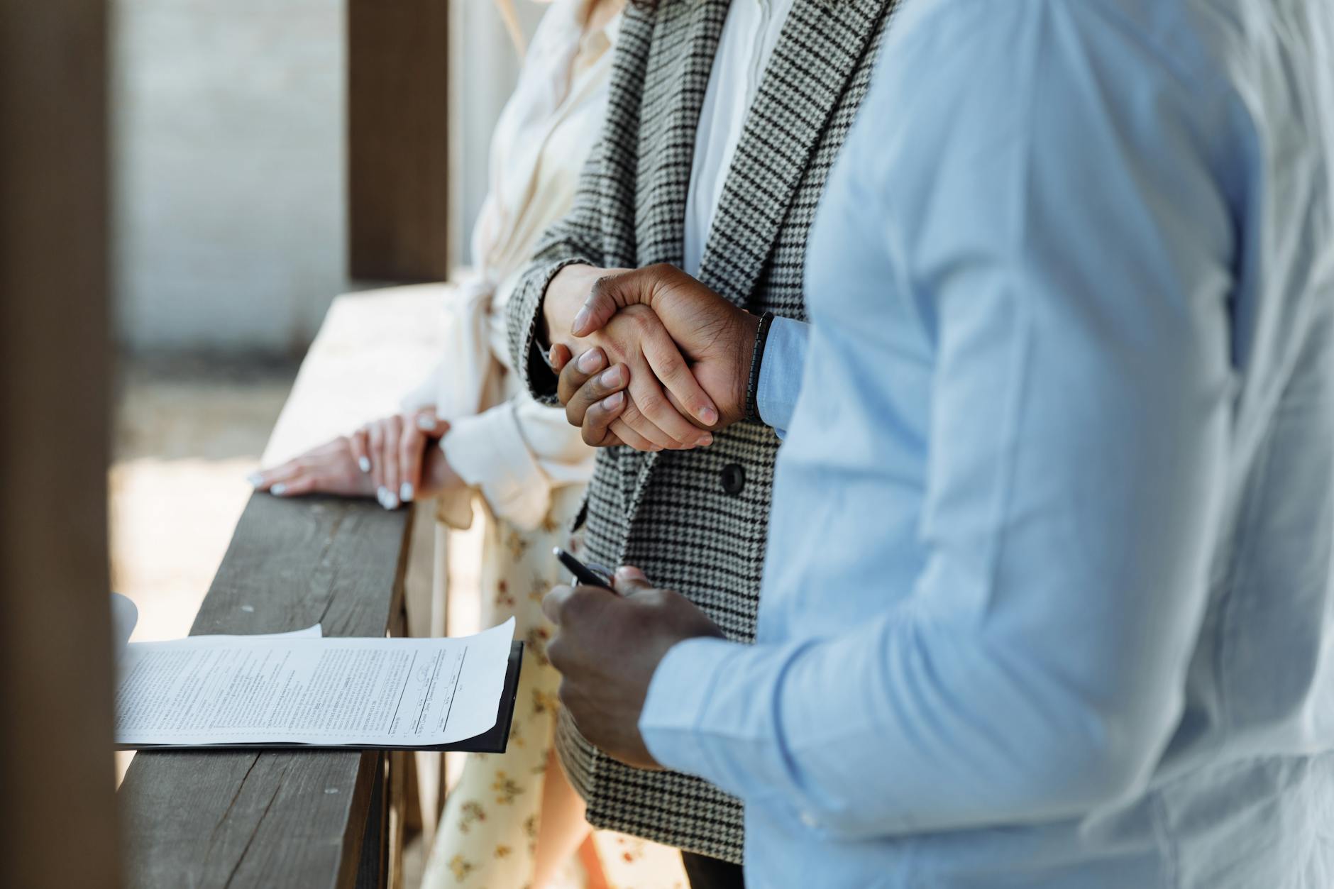 Business handshake representing new employment agreements and compensation structures