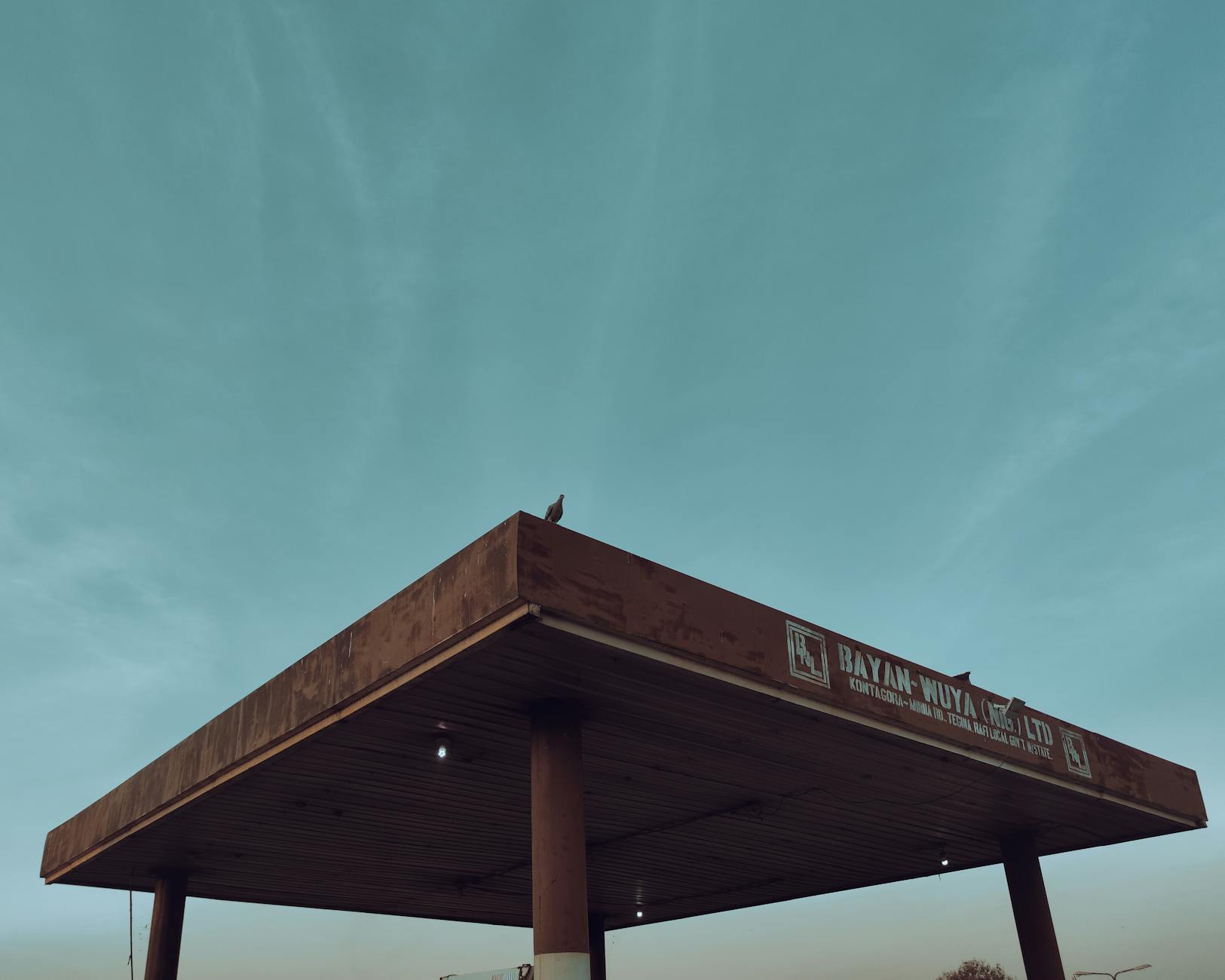 Modern gas station with covered charging area and updated amenities for electric vehicle customers