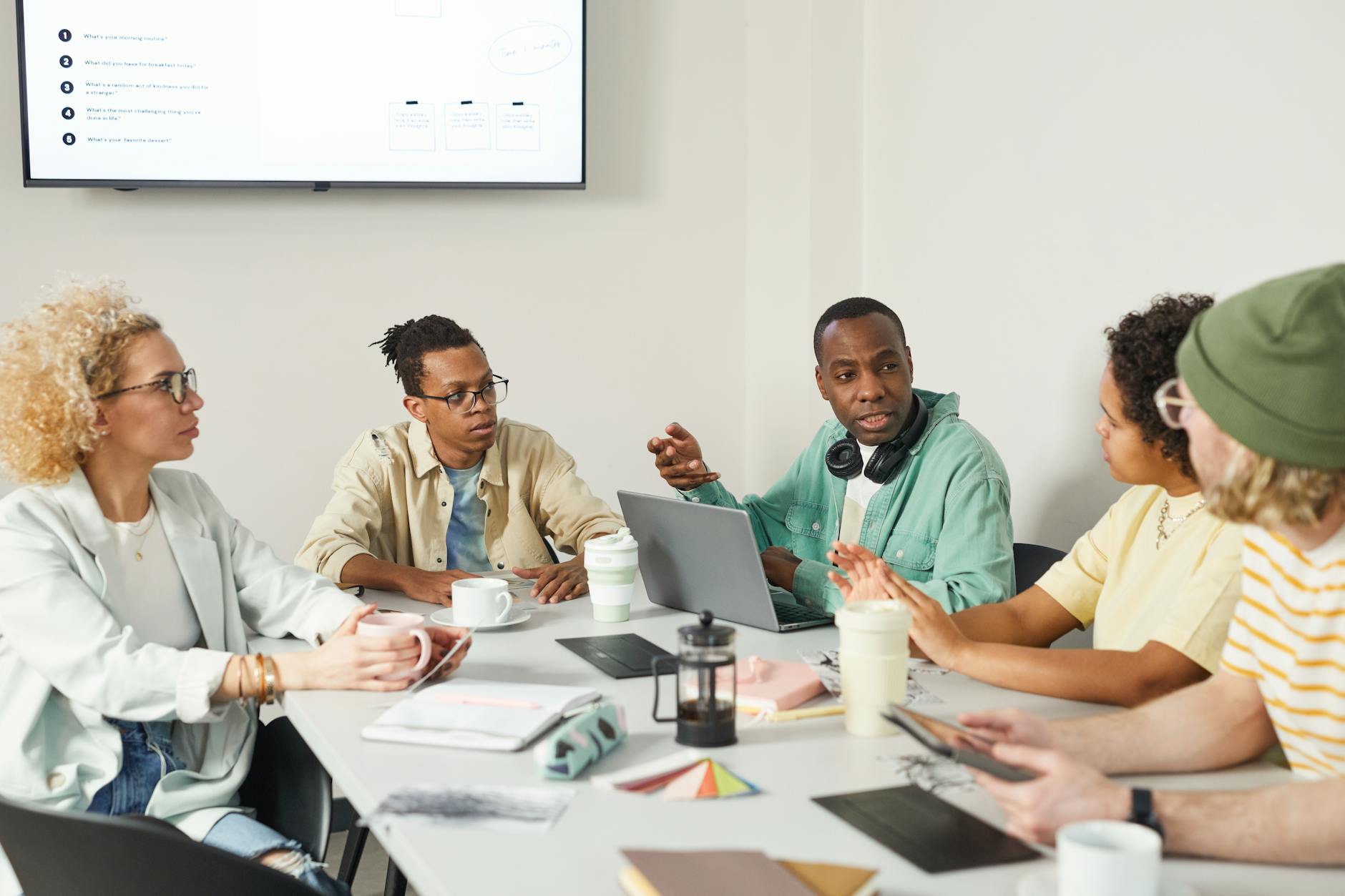 Business professionals in meeting discussing workplace policies and benefits
