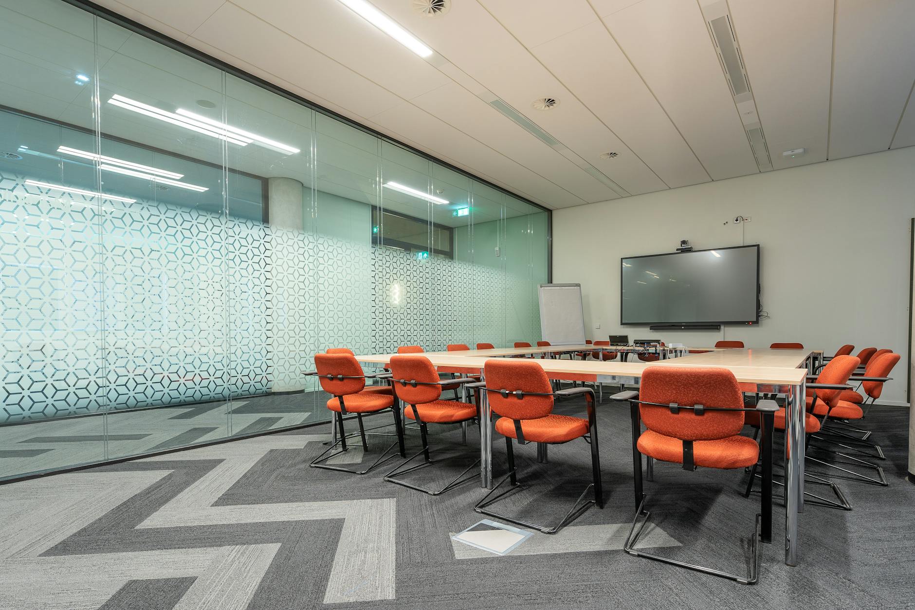 Contemporary conference room with large table and video conferencing equipment