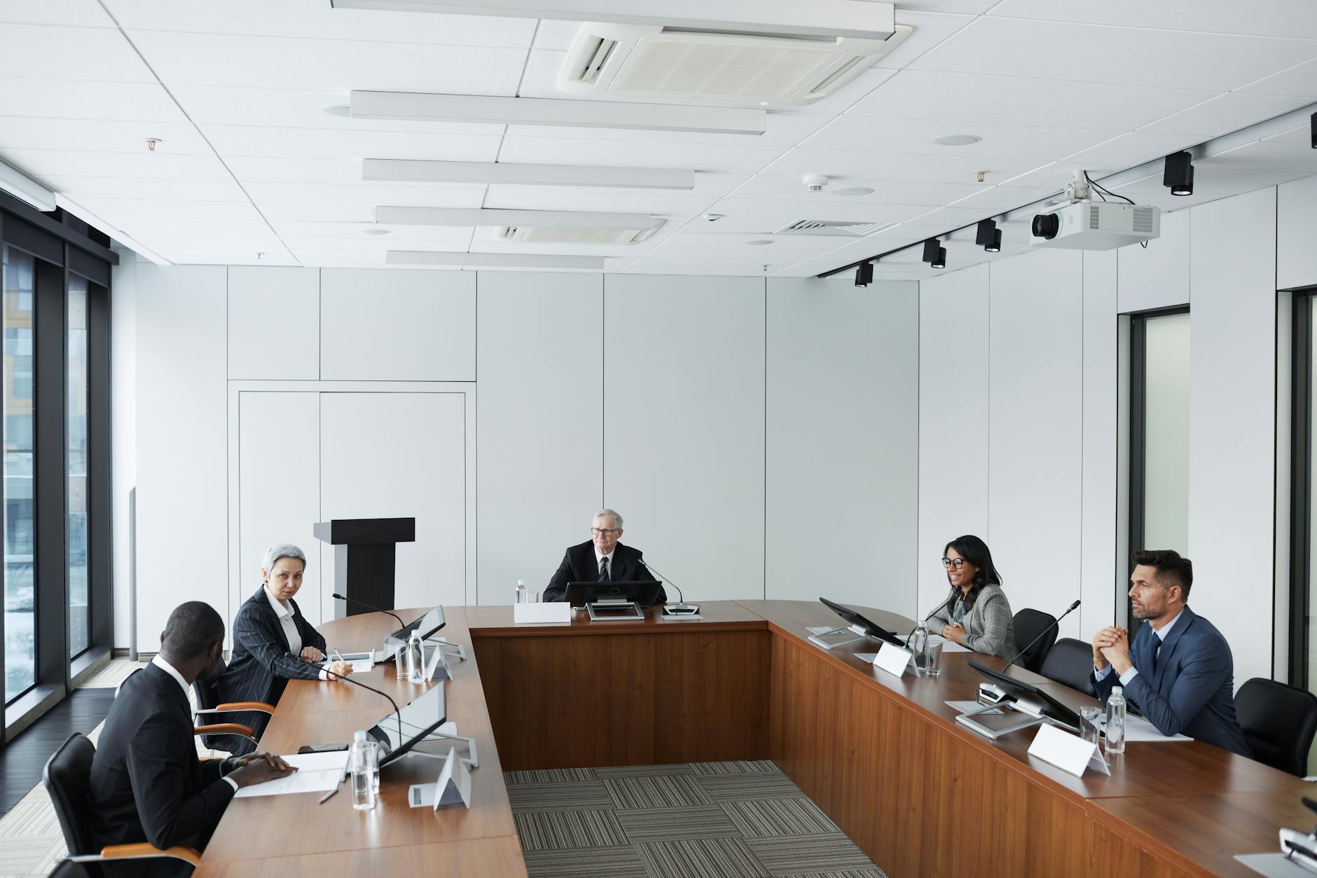 Professional video conference call displayed on computer screen with multiple participants