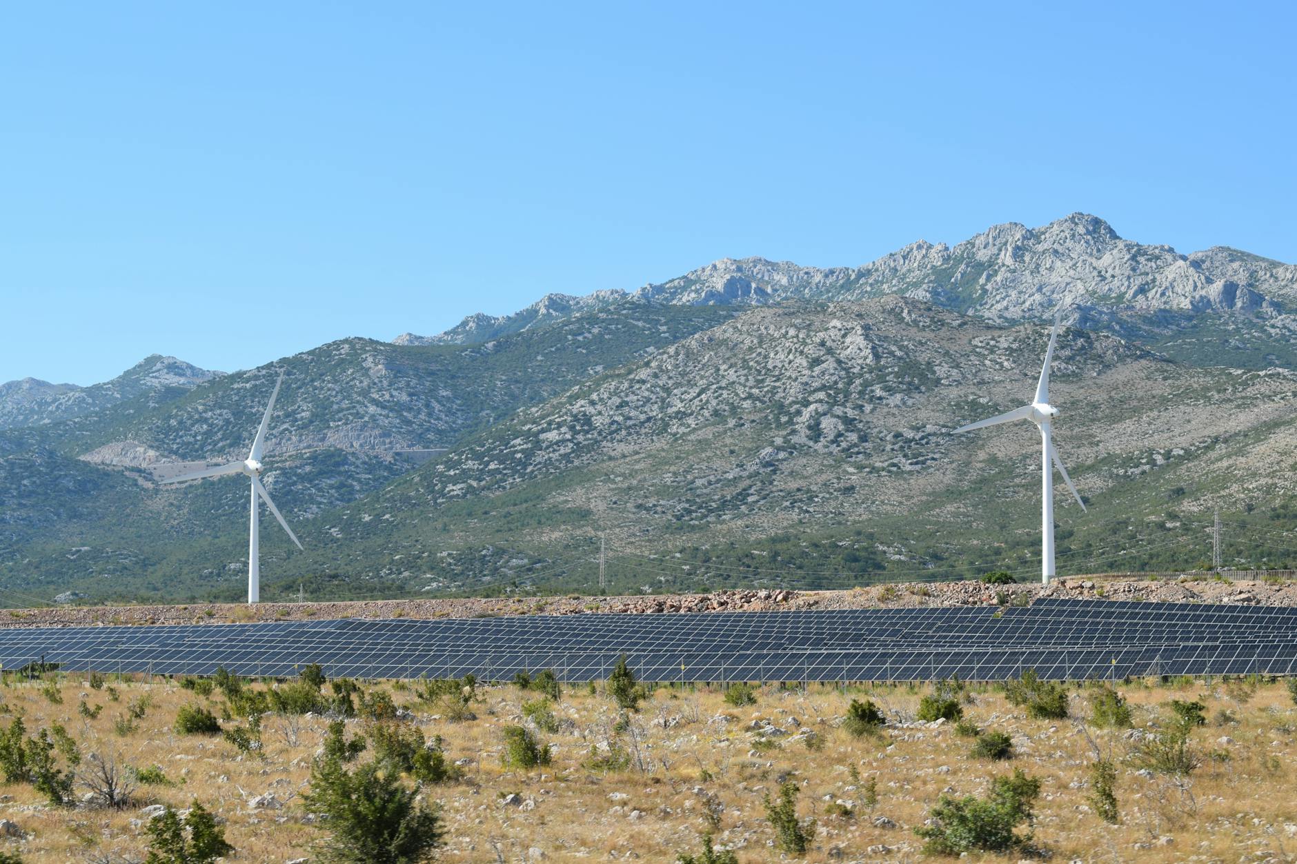 Solar panels and wind turbines in sustainable energy installation