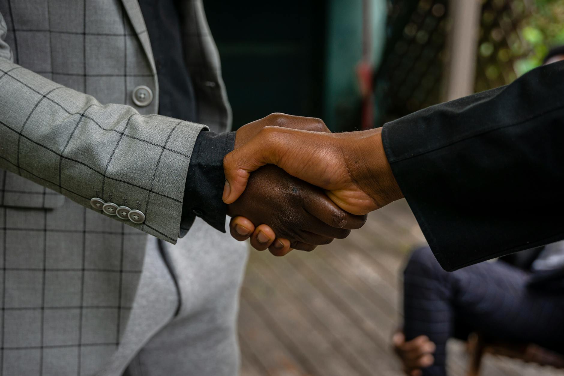 Professional handshake representing new executive compensation agreements and corporate governance