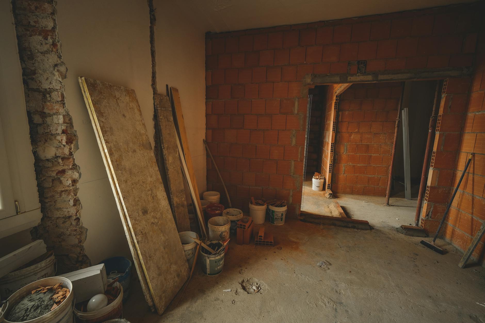 Building renovation and conversion construction site with workers and equipment