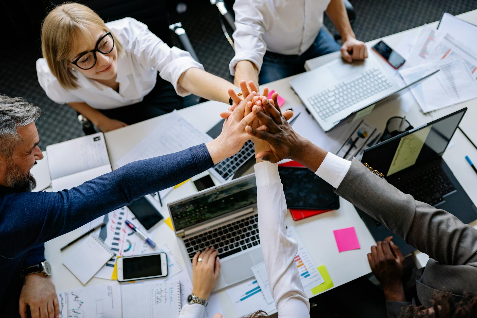 Diverse team of employees collaborating around a conference table planning sabbatical coverage strategies