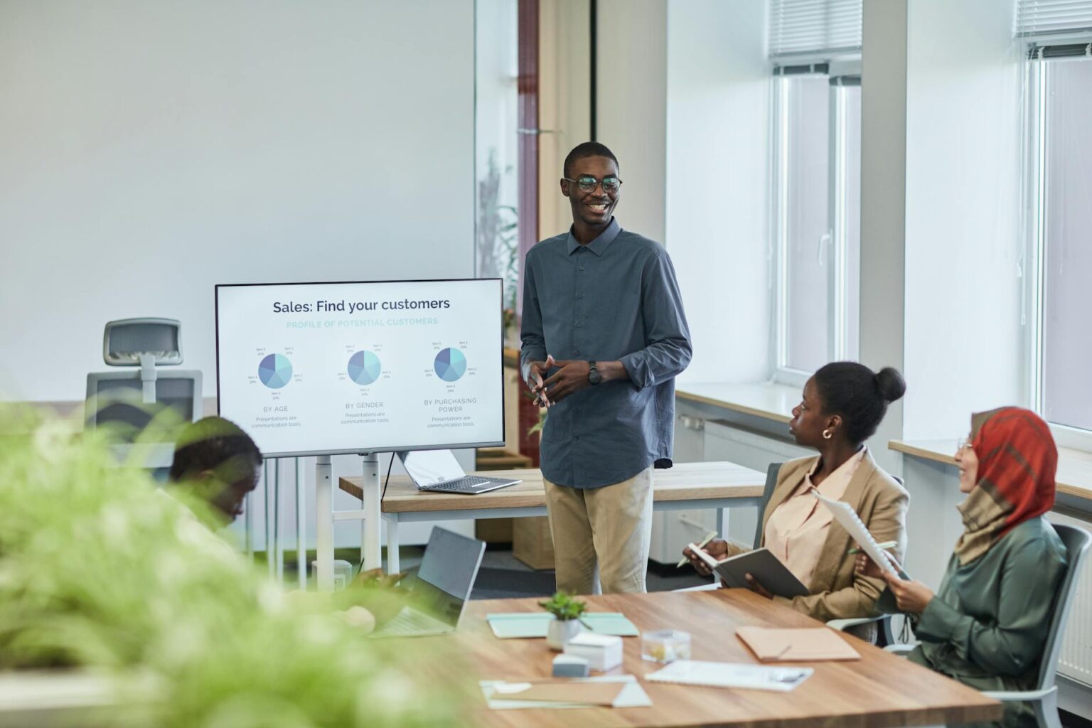 Major Consulting Firms Are Downsizing Their MBA Recruiting Programs Professional business presentation in modern conference room with people reviewing documents
