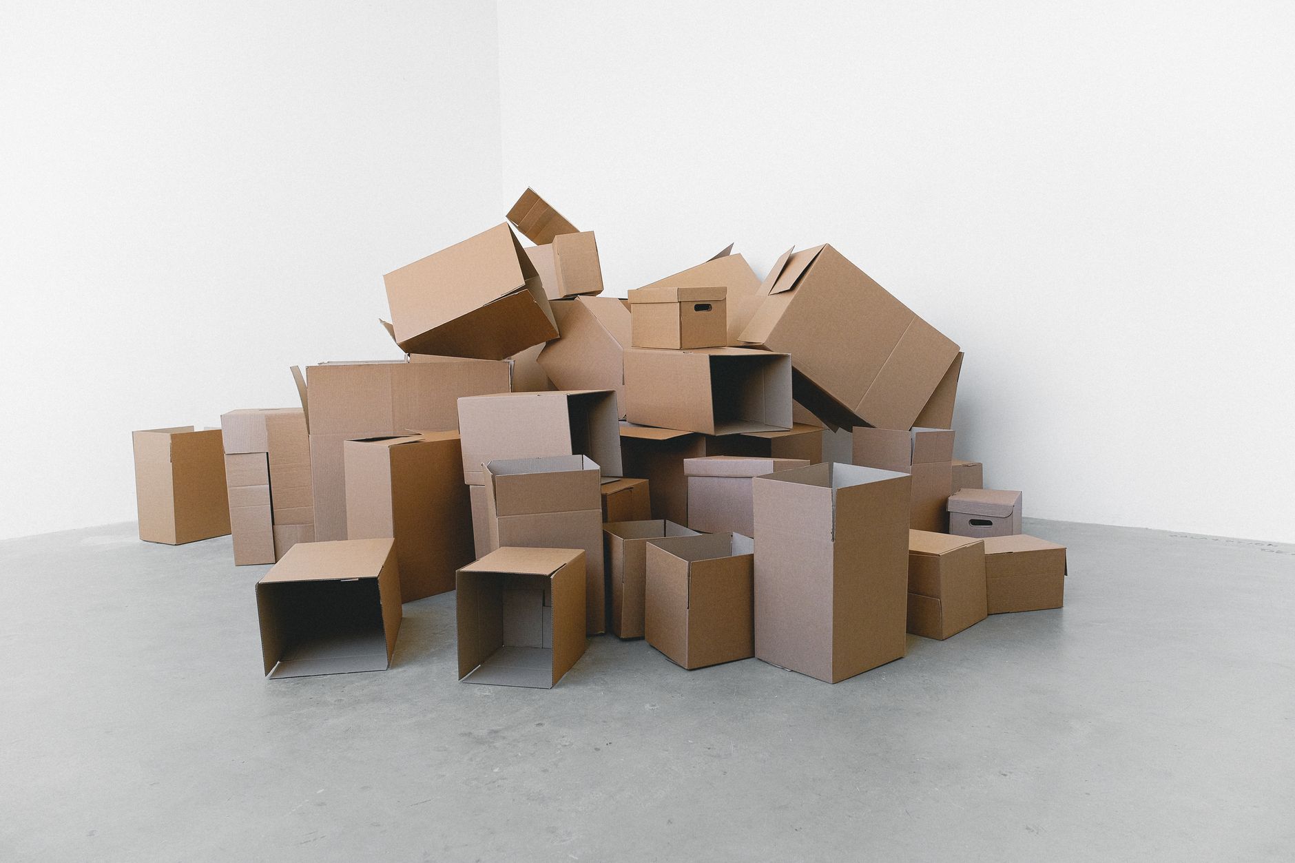 Cardboard moving boxes stacked in an office hallway during a corporate relocation