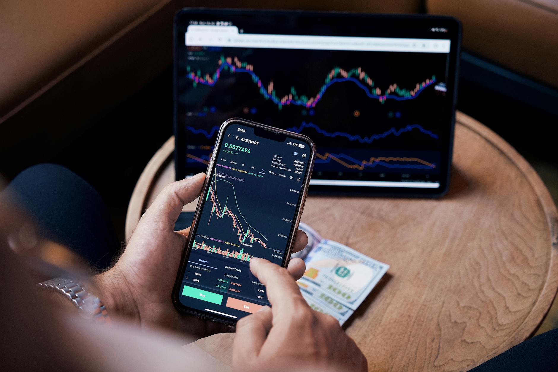 A trader monitors stock market data on multiple screens showing price movements
