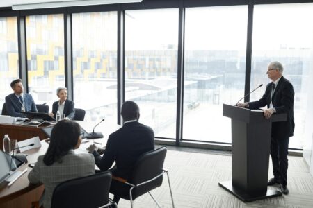 Corporate executives reviewing compensation documents in a boardroom setting