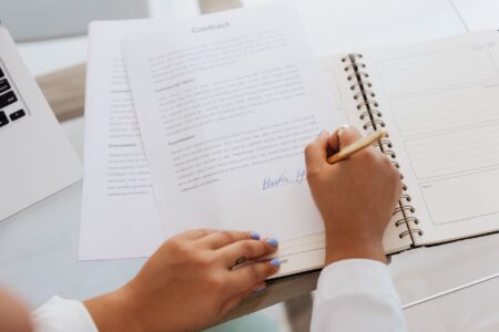 Business professionals reviewing and signing a corporate loan agreement at a conference table